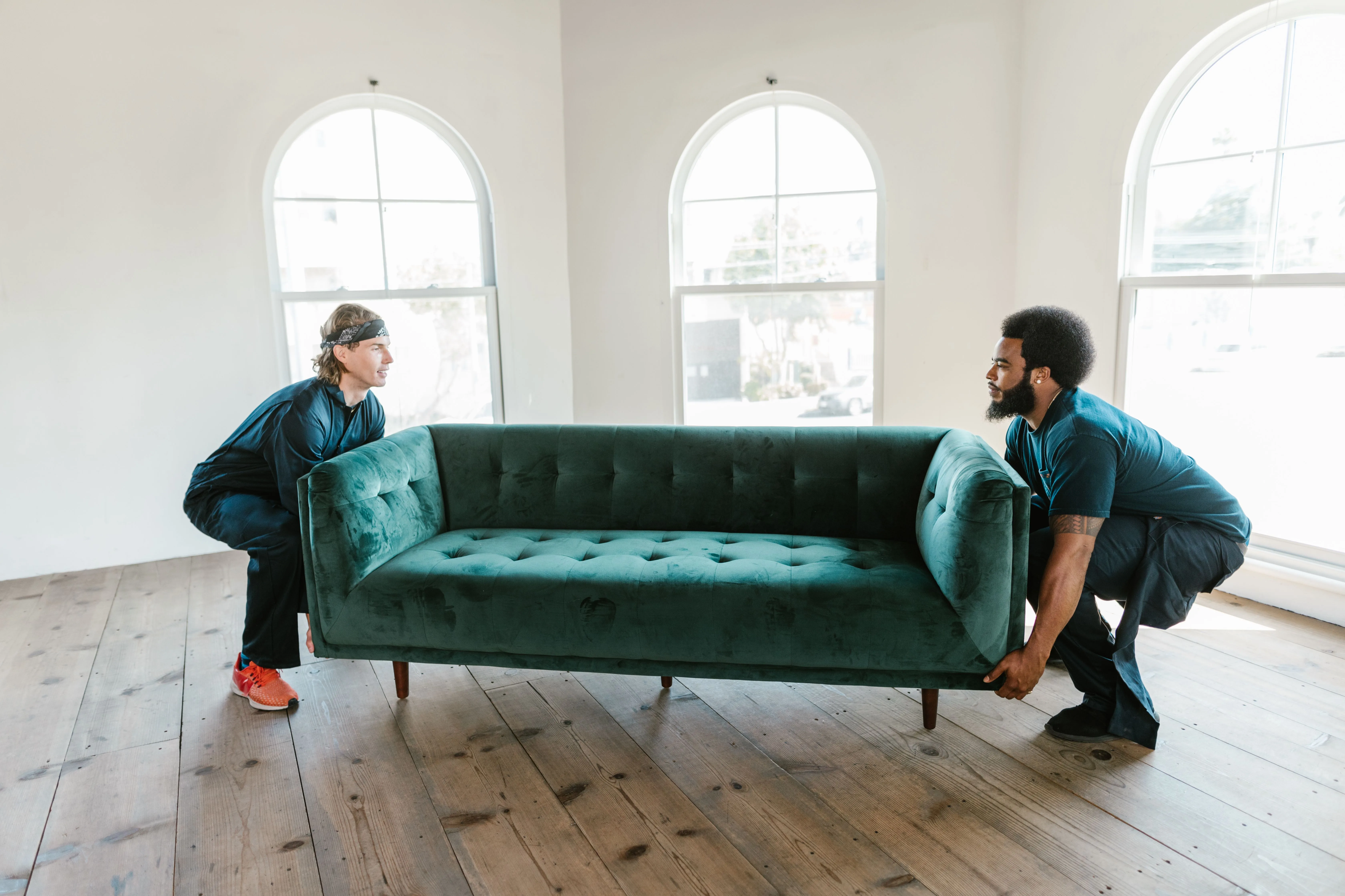 Professional movers handling furniture in a modern home